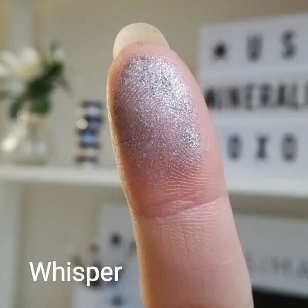 Schimmernder Swatch of Whisper on a fingertip